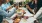 a group of people having a meal around an outdoor table